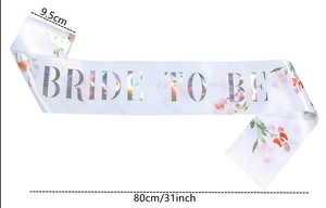Detail showing 9.5cm wide white satin Bride To Be sash with floral edges and laser text