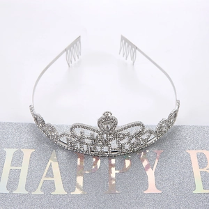 Detail of silver birthday crown headband featuring sparkling crystals and integrated hair combs