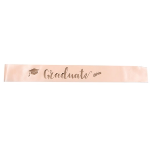 Detail of rose gold satin graduation sash with elegant Graduate script and icon