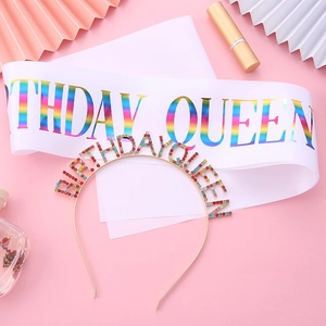 Flat lay of Birthday Queen sash with rainbow letters and a matching colorful crystal tiara