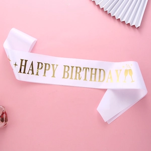 White satin birthday sash with gold foil Happy Birthday text and champagne icons