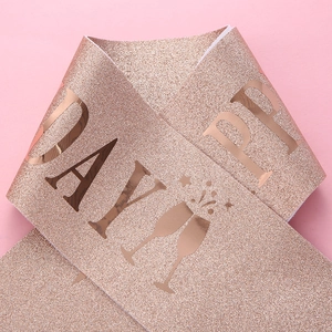 Close-up of rose gold Happy Birthday sash with glitter texture and foil lettering
