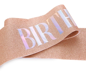 Detailed macro view of glittery rose gold birthday sash with holographic lettering