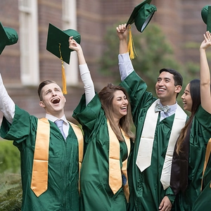 Detail of emerald green graduation gown and golden sash set during a celebration