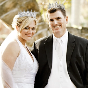 Detail of silver crystal queen tiara and sleek king crown for wedding party set