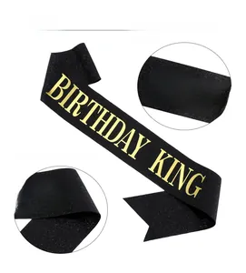 Detail of Birthday King black glitter sash with premium gold foil lettering texture