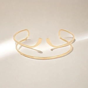 Detailaufnahme der eleganten goldfarbenen, verstellbaren Armspange in minimalistischem Design