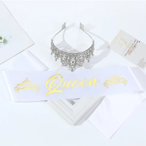 Detailed set of silver crystal crown and white satin sash with gold Queen lettering
