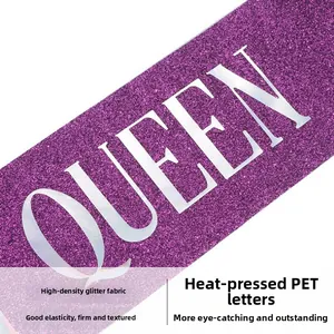 Close-up of purple glitter sash with shiny silver QUEEN lettering for birthday party