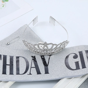 Macro detail of rhinestone birthday crown with glitter sash and safety pin for women