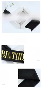 Detail of glittery black Birthday King sash with shiny gold font for party celebrations