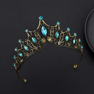 Detailed close-up of vintage gold tiara with blue crystals and black rhinestones