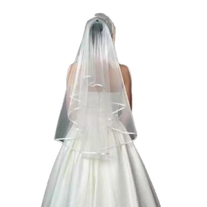 Double-layer ivory bridal veil with satin edge paired with a white strapless gown