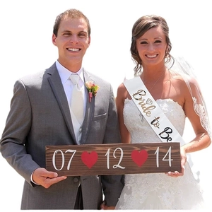 Detail of Bride to Be satin sash and a custom wooden date plaque with red hearts