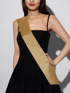 Detailed view of glittering gold sash with sparkling sequins for party celebrations