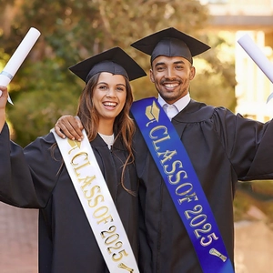 Class of 2025 graduation sash in white and navy blue worn by graduates on campus