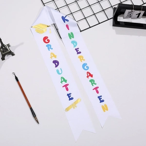 White satin kindergarten graduation sash with colorful letters and golden foil motifs