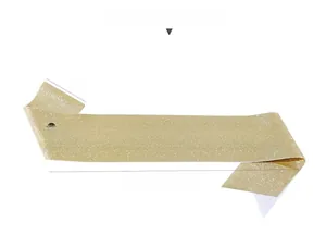 Detail of glittery gold fabric sash with black OFFICIALLY RETIRED lettering for parties