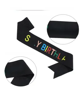 Detail of black glitter fabric birthday sash with colorful IT'S MY BIRTHDAY printing