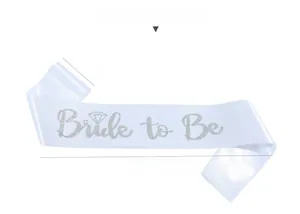 Close-up of white satin Bride to Be sash with silver glitter lettering for wedding decor