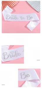 Close-up of white satin Bride to Be sash with silver glitter lettering for hen party