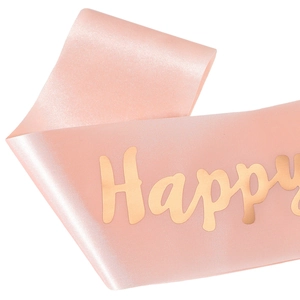 Gros plan sur l'écharpe d'anniversaire en satin rose avec texte Happy doré brillant