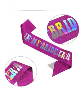 Detail of rose pink glitter bridal sash featuring iridescent IN MY BRIDE ERA lettering