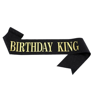 Sparkling black fabric Birthday King sash with glossy gold foil lettering for men's party