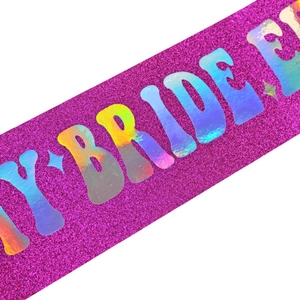 Glittery magenta bridal sash featuring holographic In My Bride Era laser lettering
