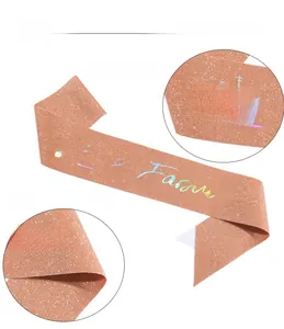 Detail of rose gold glitter sash with holographic 21 & Fabulous text for birthday party