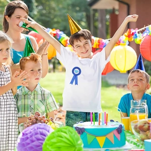 Close-up of blue Birthday Boy ribbon badge with colorful polka dots for party