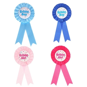 Birthday Boy and Girl badge rosettes in pink and blue for party celebrations