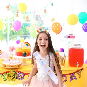 Birthday party set featuring white satin sash and colorful headband with celebratory text