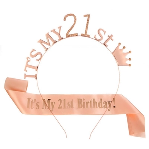 Detail of rose gold 21st birthday crown and satin sash set for party celebration