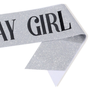 Detail of silver sequin sash with black bold Birthday Girl text for party decorations