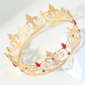 Elegant gold crown with fleur-de-lis motifs and red rhinestones on white stand