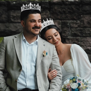 Detail of silver wavy king crown and crystal rhinestone tiara worn by models
