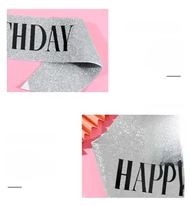 Detail of silver glitter birthday sash with black Happy Birthday lettering for parties