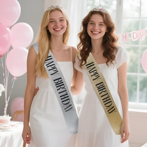 Close-up of glitter birthday sash and crystal tiara set on models at a birthday party
