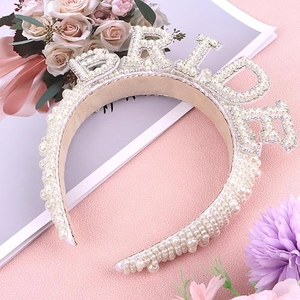 Detail view of pearl headband featuring BRIDE rhinestone lettering for bridal parties