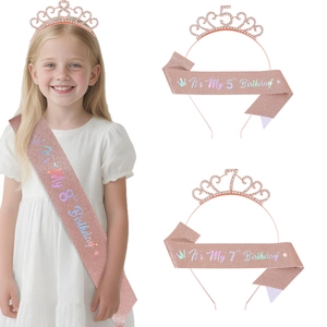 Close-up of rose gold rhinestone princess crown and glittery birthday sash for girls