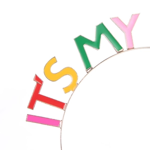 Macro detail of IT'S MY metal birthday headband with colorful enamel dripping finish