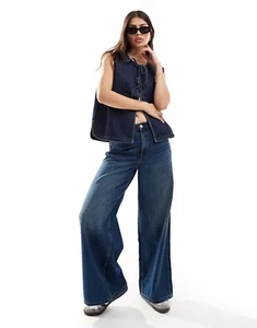 Detail of a dark blue sleeveless denim vest with stylish lace-up front and A-line cut