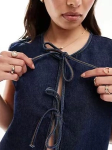 Dark blue sleeveless denim vest for women with front lace-up bows and contrast stitching