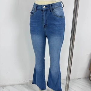 Detail of high-waisted flared jeans in blue wash with raw hem and retro bell-bottom cut