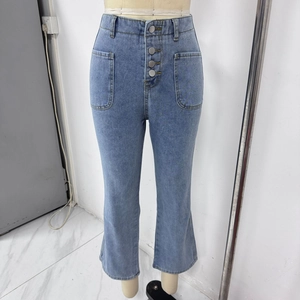 Detail of high waisted light blue flare jeans with four metal buttons and large front pockets