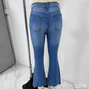 Detail view of high-waisted flare jeans back with dual pockets and frayed hemline
