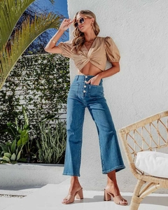 Full-length view of high-waisted wide-leg jeans with four-button fly and front patch pockets