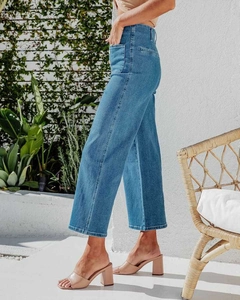 Detail view of high waist wide leg blue jeans with classic denim washing texture