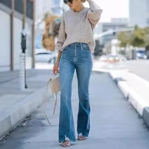 Street style view of women's vintage stretch flare jeans in light blue denim